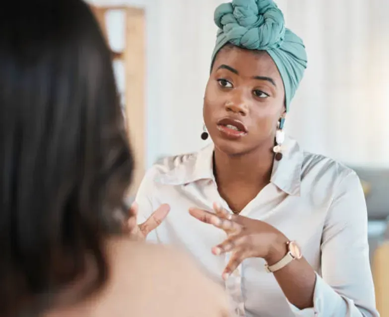 Ama Ronke in a collaborative consultation, listening and speaking with warmth